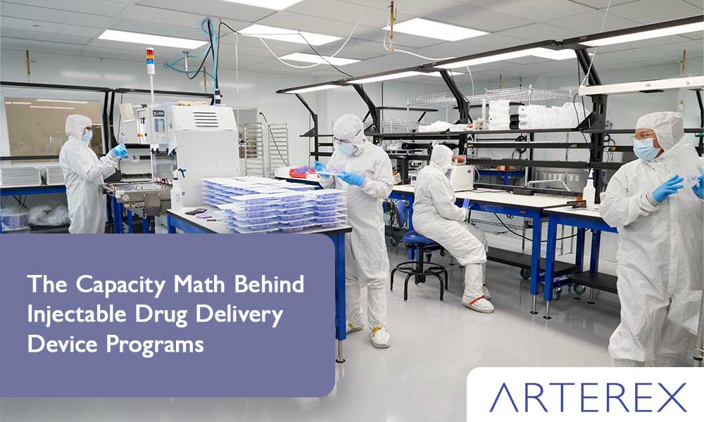 Automated assembly line producing injectable drug delivery devices inside an ISO Class 8 cleanroom